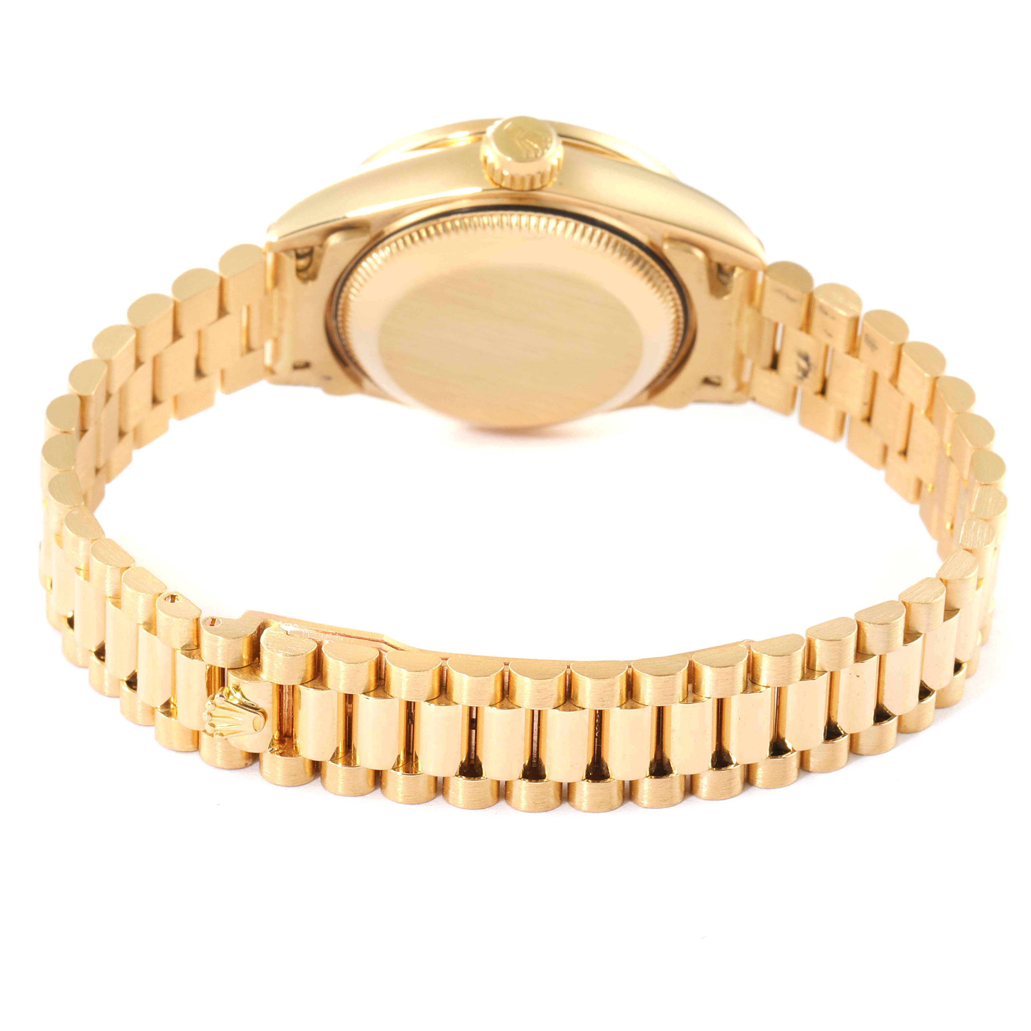 The image shows the backside of a Rolex President 69138 Women
s Yellow Gold Champagne Dial 69138 Women
s Yellow Gold Champagne Dial model watch, highlighting the clasp and bracelet.