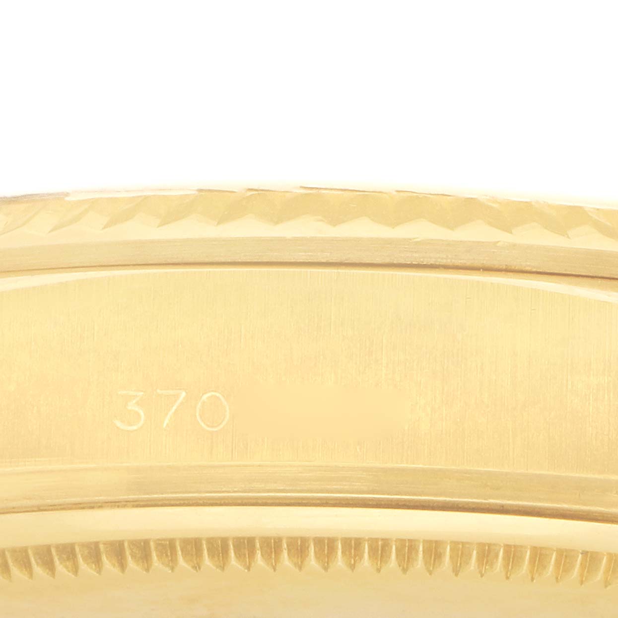The image shows a close-up of the gold bezel and side engraving of a Rolex President 18038 Men's Yellow Gold Champagne Dial watch.