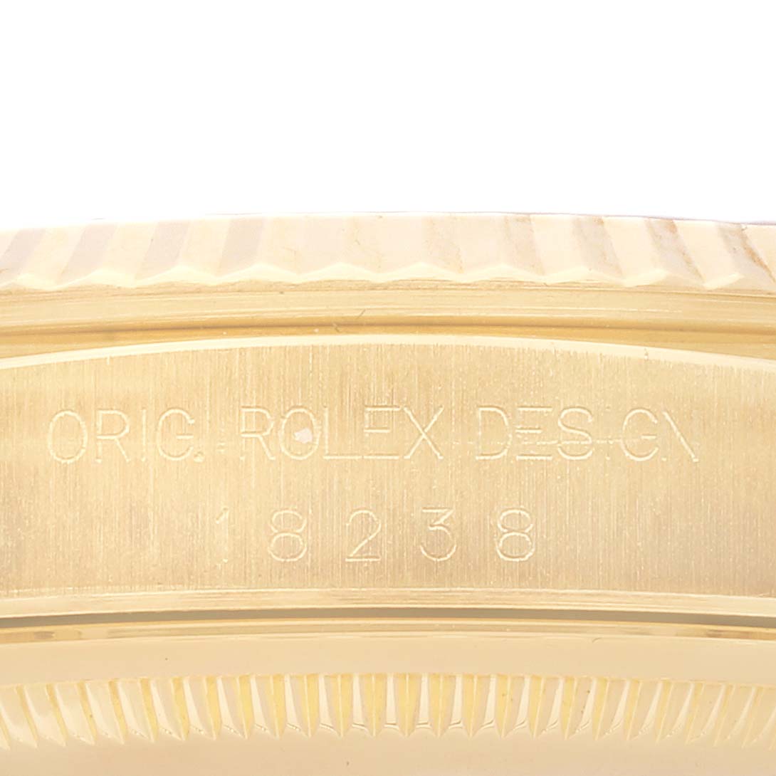 This image shows a close-up of the side engraving and fluted bezel on a Rolex President 18238 Men
s Yellow Gold Champagne Dial 18238 Men
s Yellow Gold Champagne Dial model.