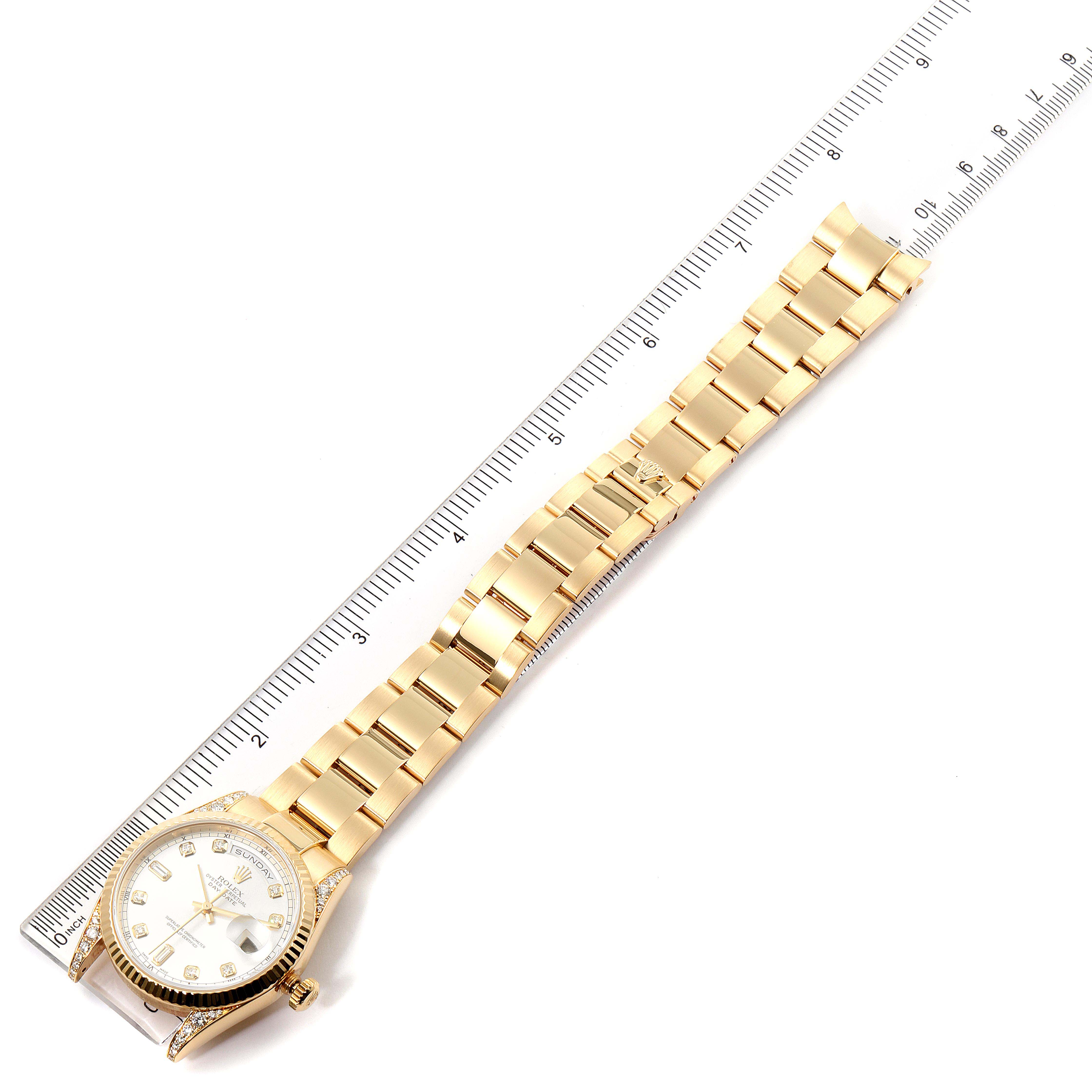 The image shows a Rolex President 118338 Men
s Yellow Gold Silver Dial 118338 Men
s Yellow Gold Silver Dial watch in gold, lying flat with a ruler measuring its bracelet length.