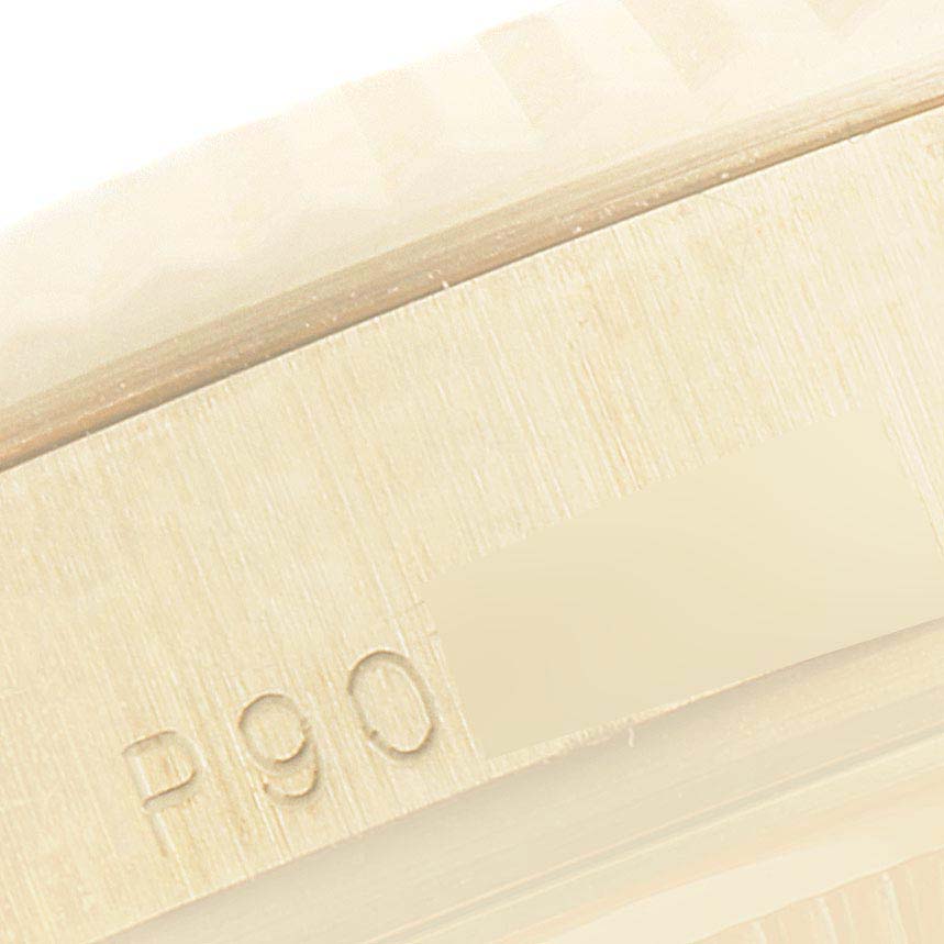 This is a close-up view showing part of the case and serial number of the Rolex President 118338 Men
s Yellow Gold Silver Dial 118338 Men
s Yellow Gold Silver Dial model watch.