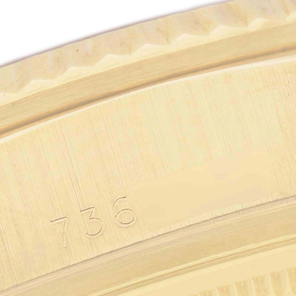 The image shows an angled close-up of the bezel and part of the case of a Rolex President 18038 Men's Yellow Gold White Dial watch, highlighting engraved numbers.