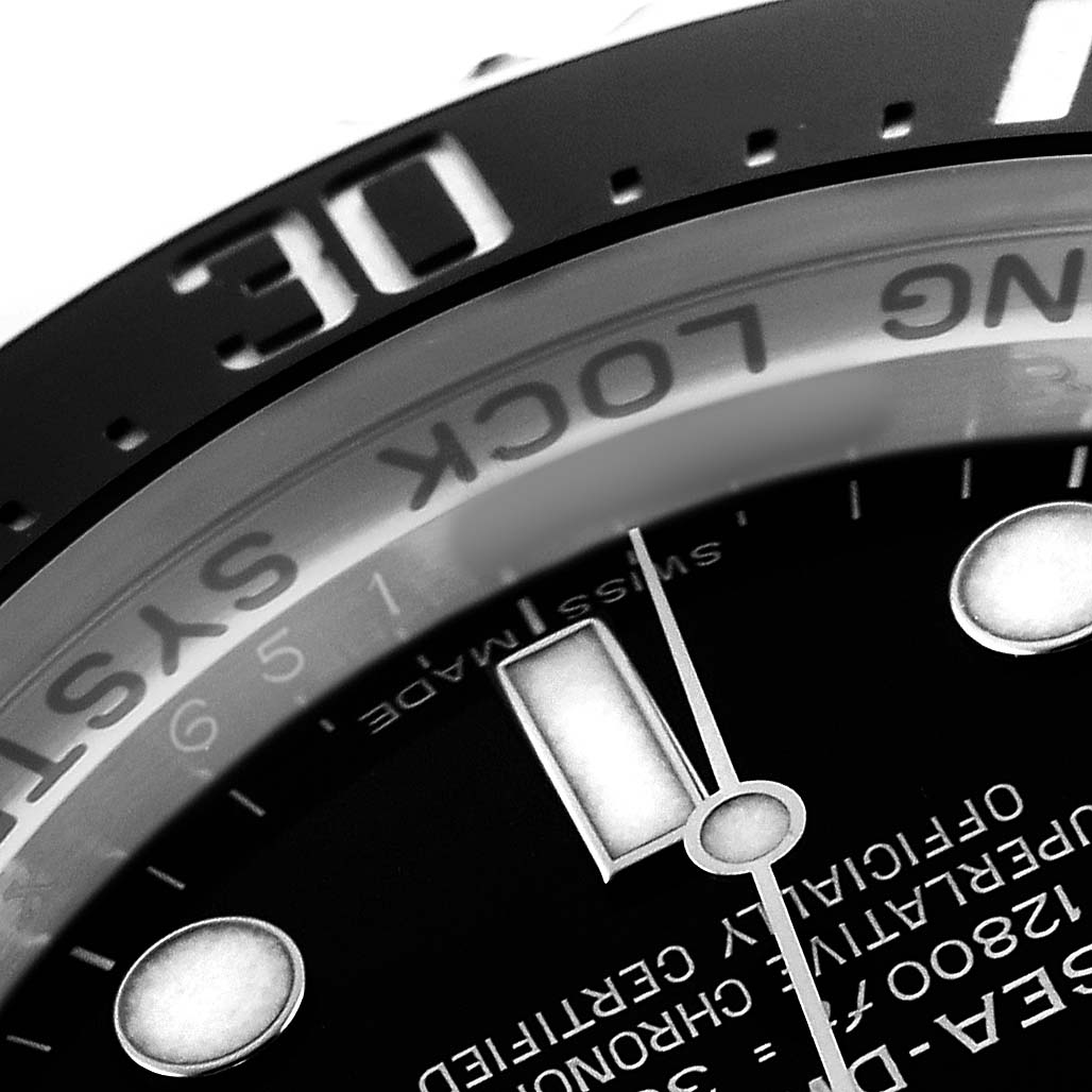 The image shows a close-up of the bezel and part of the dial on a Rolex Sky-Dweller 116660 Men's Stainless Steel Black Dial, highlighting the words and markers.