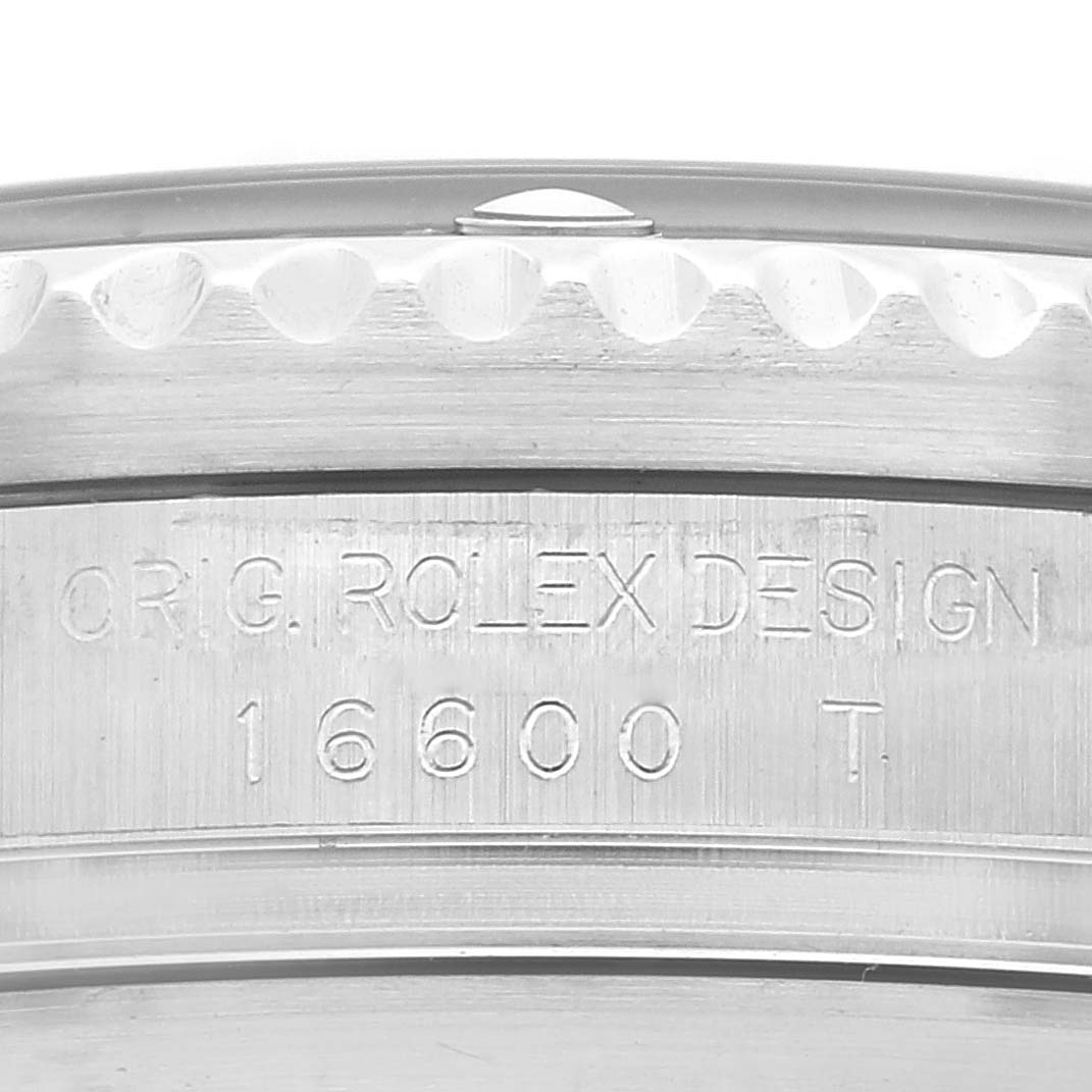 This close-up image shows the engraved serial number "16600" and "ORIG. ROLEX DESIGN" on the case back of a Rolex Sea-Dweller 16600T Men's Stainless Steel Black Dial 16600T Men's Stainless Steel Black Dial watch.