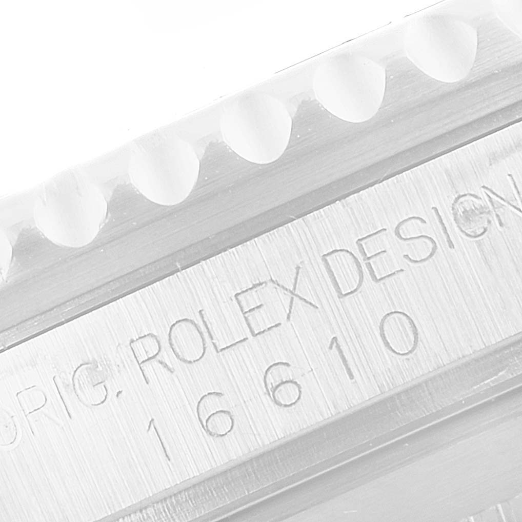 The image shows a close-up of the serial number and design engraving on the case side of a Rolex Submariner 16610 Men
s Stainless Steel Black Dial 16610 Men
s Stainless Steel Black Dial watch.
