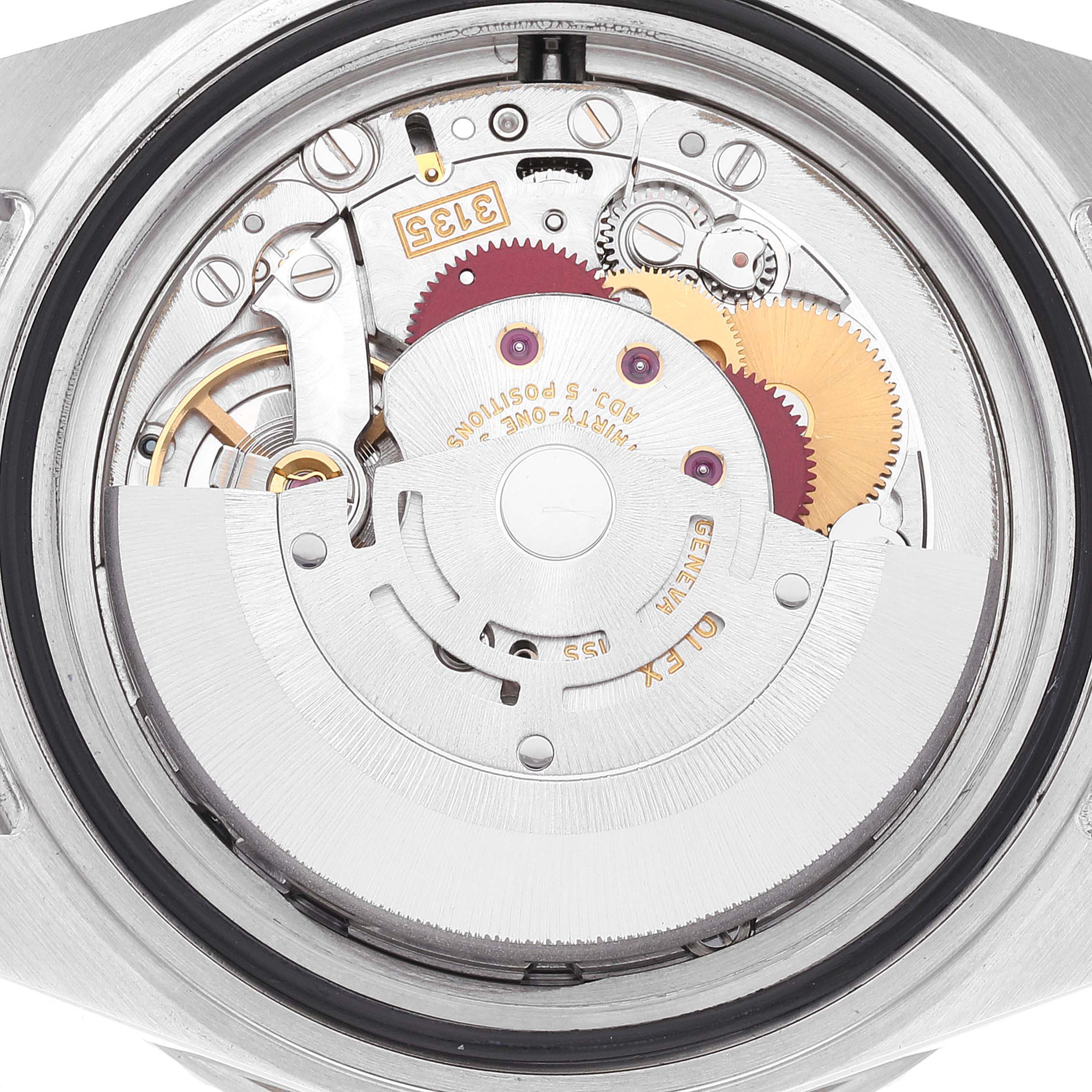 The image shows the inner mechanism of a Rolex Submariner 16610 Men's Stainless Steel Black Dial 16610 Men's Stainless Steel Black Dial watch from a back angle, highlighting gears and inscriptions.