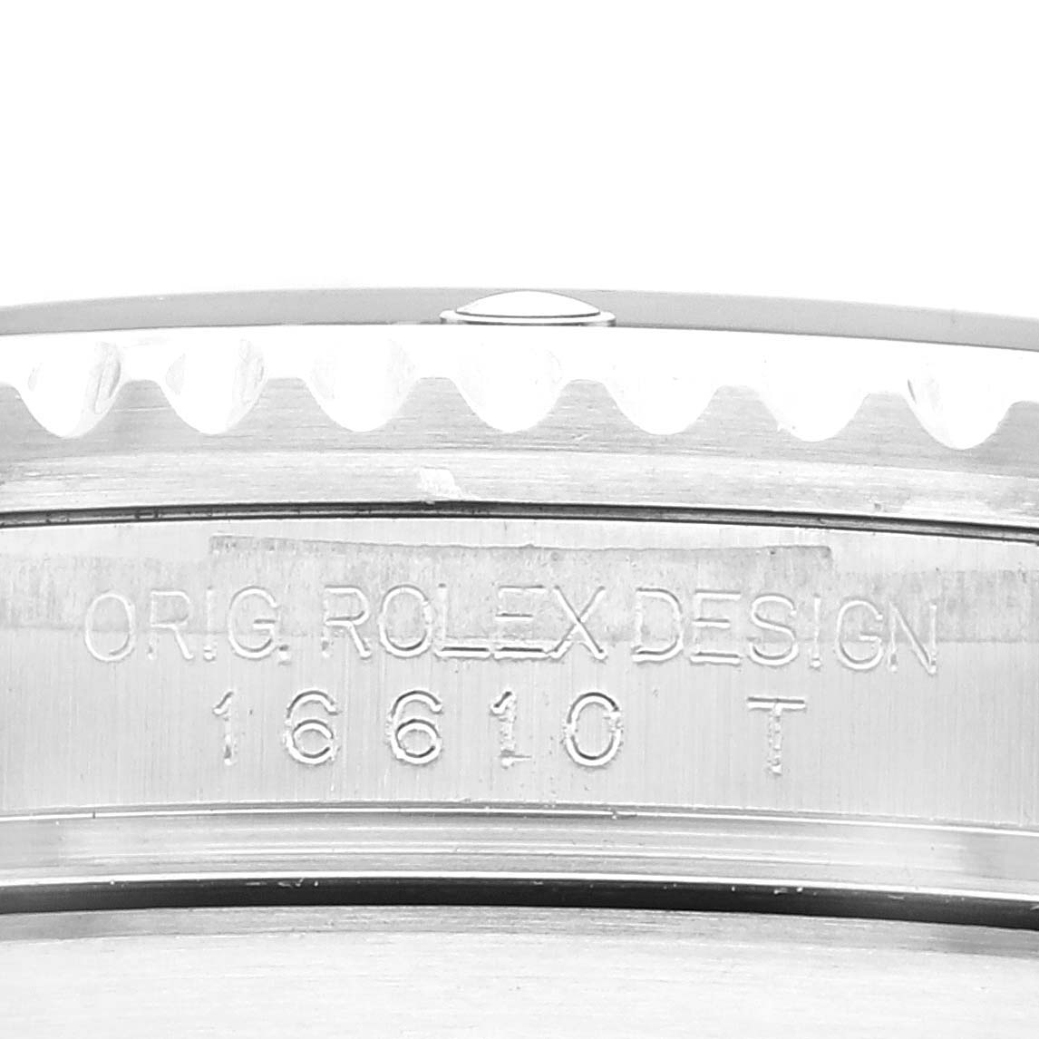 The image shows a close-up view of the engraving on the side of a Rolex Submariner 16610 Men's Stainless Steel Black Dial 16610 Men's Stainless Steel Black Dial model 16610 T watch case.