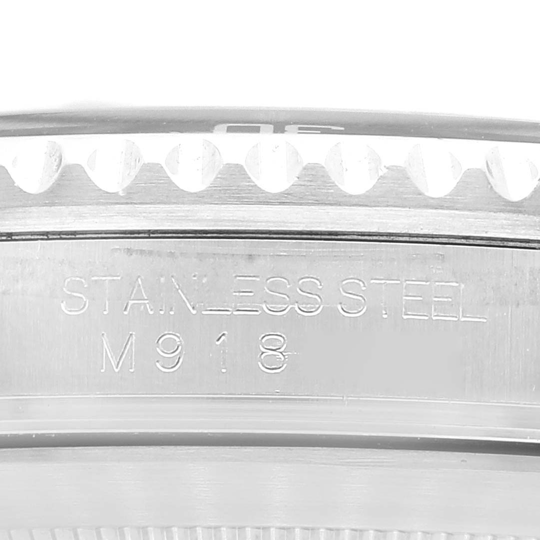 The image shows a close-up of the bezel and side of the stainless steel casing of a Rolex Submariner 16610 Men's Stainless Steel Black Dial 16610 Men's Stainless Steel Black Dial watch with the engravings visible.