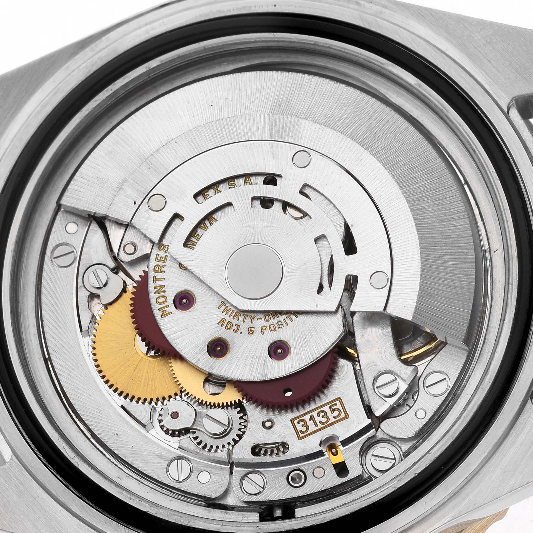 The image shows the inner mechanical movement of a Rolex Submariner 16613 Men's Steel and Gold (two tone) Blue Dial 16613 Men's Steel and Gold (two tone) Blue Dial, featuring gears and the rotor.
