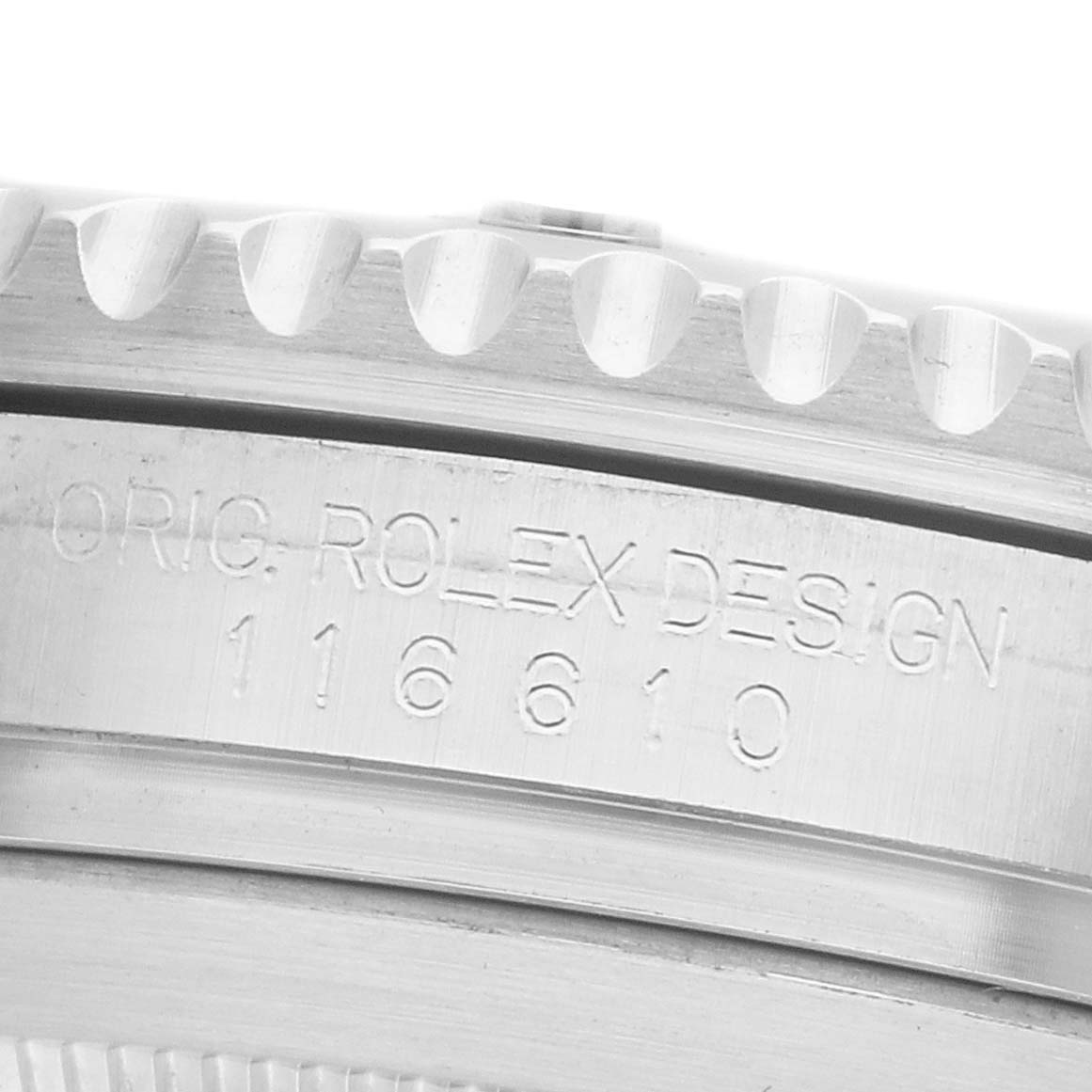 The image shows a close-up of a Rolex Submariner 116610LN Men's Stainless Steel Black Dial's engraved side, featuring the model number and design text.