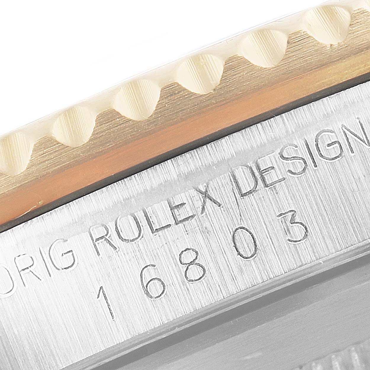 Close-up of the side view of the Rolex Submariner 16803 Men's Steel and Gold (two tone) Black Dial 16803 Men's Steel and Gold (two tone) Black Dial model, showing the bezel and engraved model number (16803).