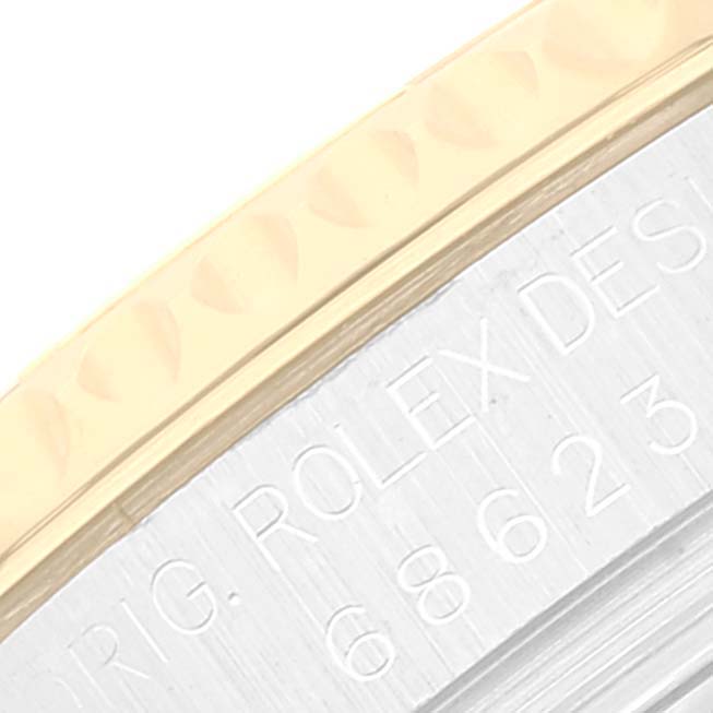 This close-up image shows the side of the bezel and part of the engraved case of the Rolex Yacht-Master 68623 Men
s Steel and Gold (two tone) Blue Dial 68623 Men
s Steel and Gold (two tone) Blue Dial.