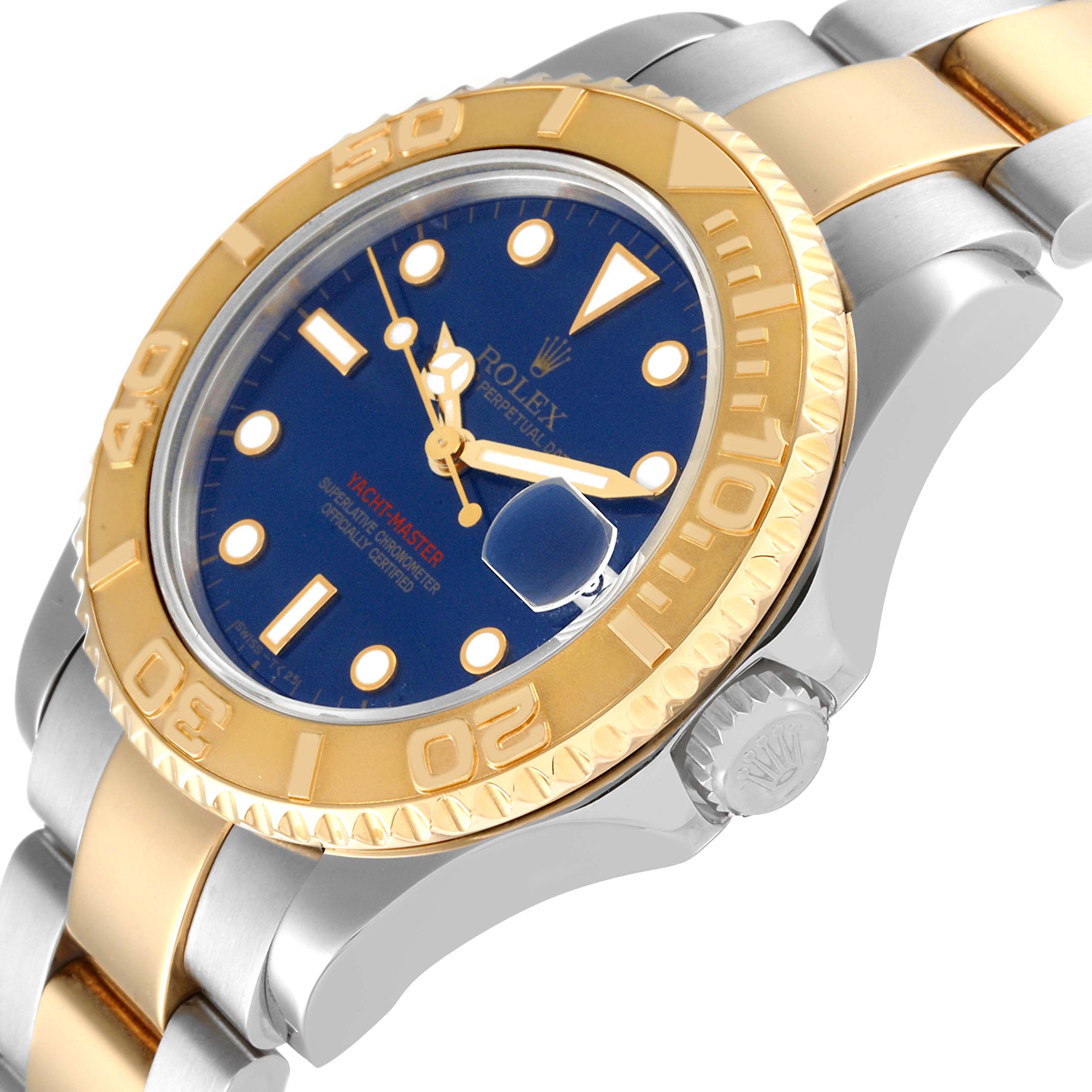 The image shows a Yacht-Master Rolex watch at an angle highlighting the gold bezel, blue dial, crown, and two-tone bracelet.