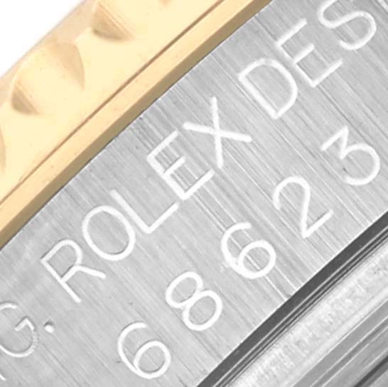 The image shows a close-up of the bezel and engraved side of the Rolex Yacht-Master 68623 Men's Steel and Gold (two tone) Champagne Dial 68623 Men's Steel and Gold (two tone) Champagne Dial watch, highlighting the brand name.