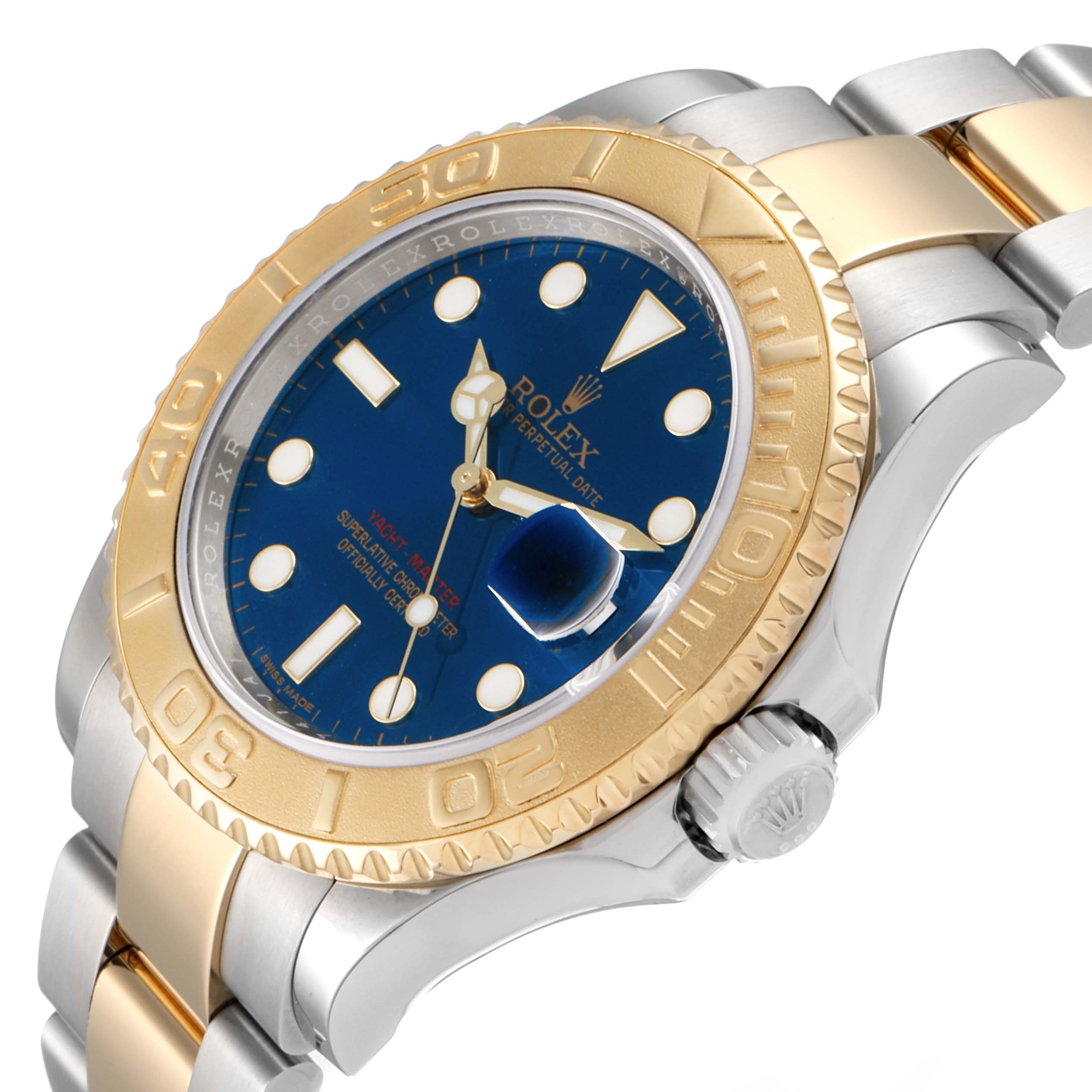 The Rolex Yacht-Master 16623 Men's Steel and Gold (two tone) Blue Dial 16623 Men's Steel and Gold (two tone) Blue Dial watch is shown from an angled view, highlighting the gold bezel, blue dial, and two-tone bracelet.