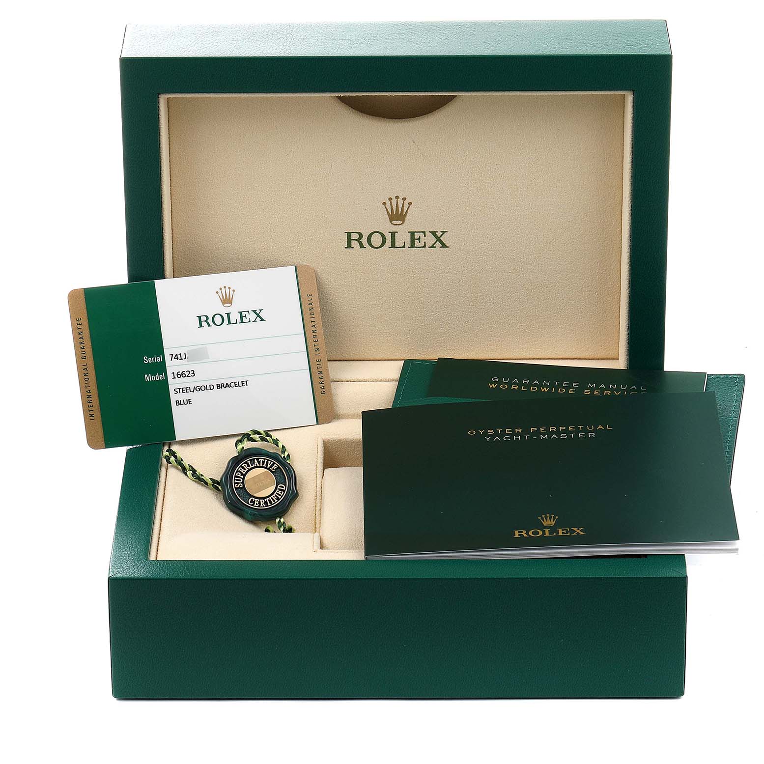The image shows the accessories for a Rolex Yacht-Master 16623 Men's Steel and Gold (two tone) Blue Dial 16623 Men's Steel and Gold (two tone) Blue Dial model 16623, including manuals, a warranty card, and a certification tag, inside a green box.