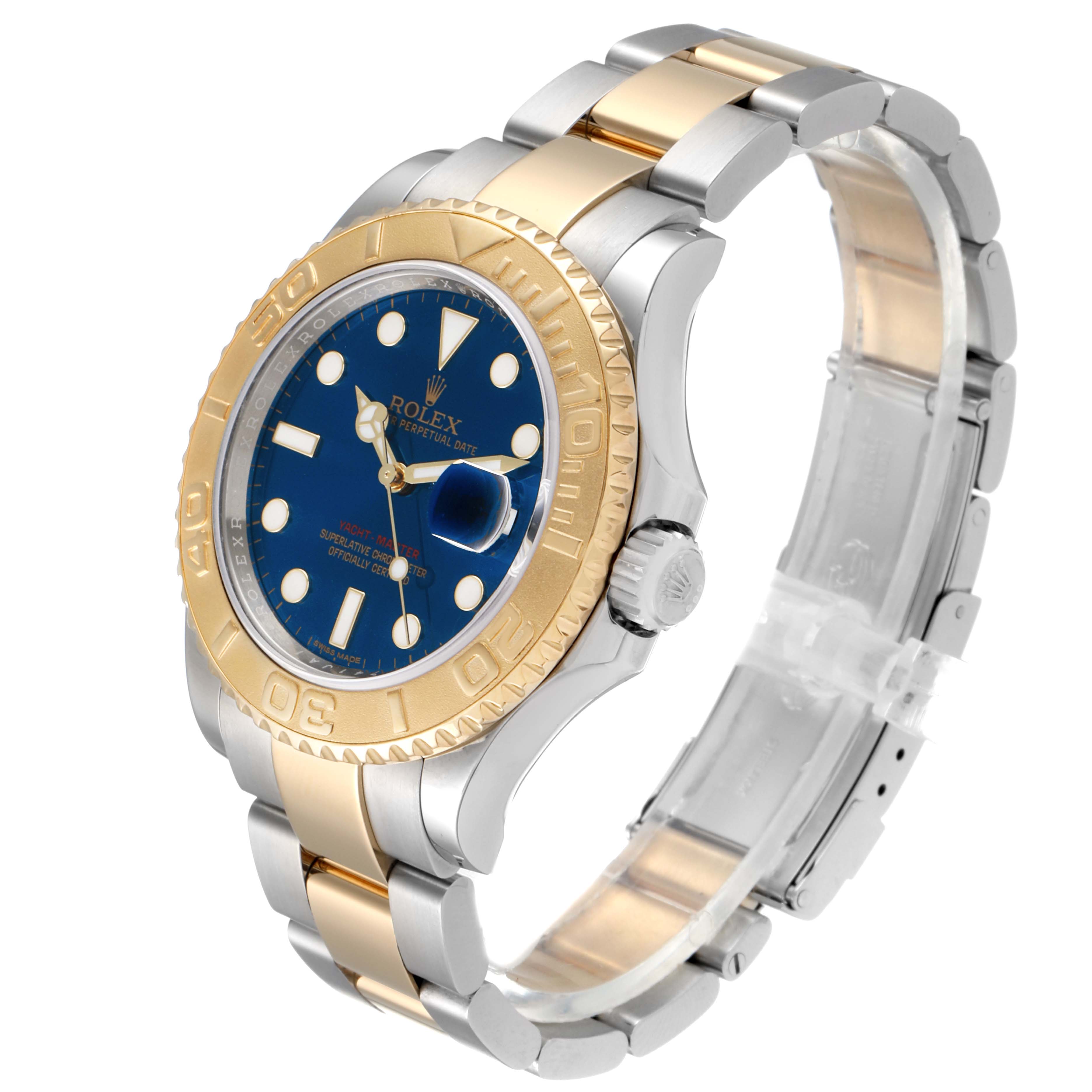 The Rolex Yacht-Master 16623 Men's Steel and Gold (two tone) Blue Dial 16623 Men's Steel and Gold (two tone) Blue Dial watch is shown at an angle, highlighting its blue dial, gold bezel, and two-tone bracelet.