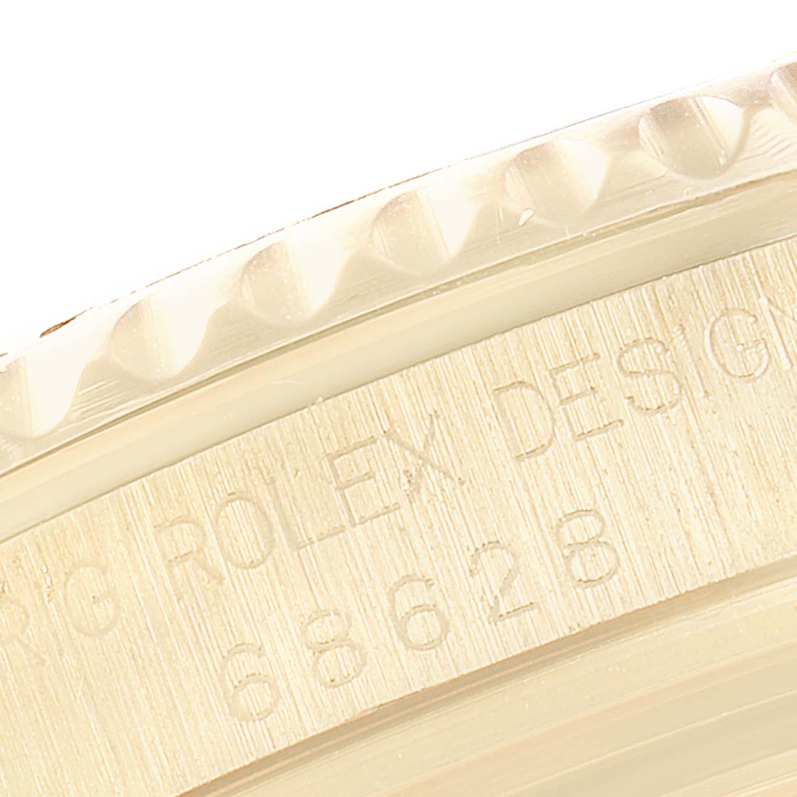 The image shows a close-up of the bezel and part of the case back of a Rolex Yacht-Master 68628 Men
s Yellow Gold Blue Dial 68628 Men
s Yellow Gold Blue Dial watch.