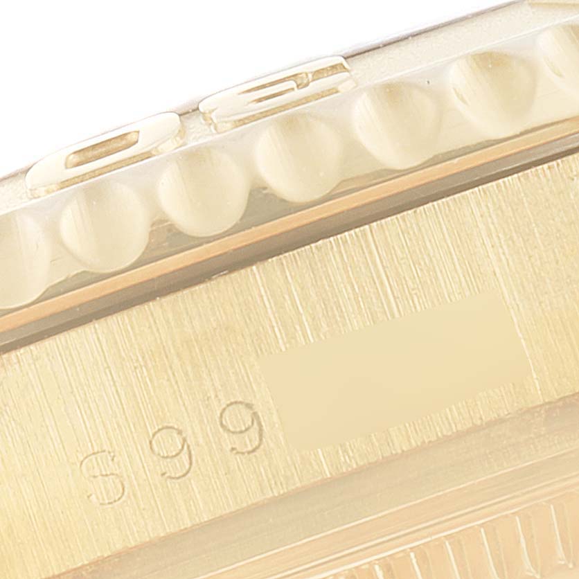 This close-up image shows the bezel and serial number engraving on a Rolex Yacht-Master 68628 Men
s Yellow Gold Blue Dial 68628 Men
s Yellow Gold Blue Dial watch.