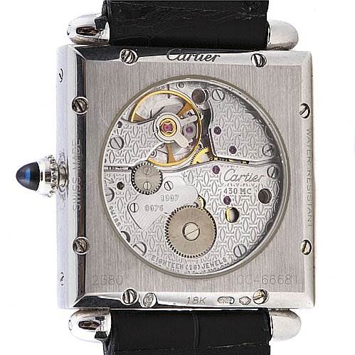 The image shows the back of a Cartier Tank Obus 2380 White Gold Silver Dial 2380 White Gold Silver Dial model watch, highlighting its movement and inscriptions.