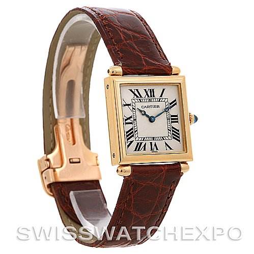 The image shows a Cartier Tank Obus Yellow Gold Silver Dial Yellow Gold Silver Dial model watch at a side angle, highlighting its leather strap and rectangular face with Roman numerals.