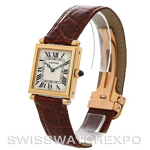 The image shows a Cartier Tank Obus Yellow Gold Silver Dial Yellow Gold Silver Dial watch at a side angle, highlighting its square face, Roman numerals, and brown leather strap.