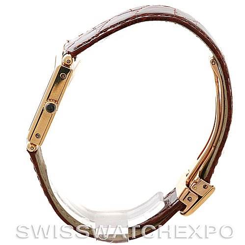 The image shows a side view of a Cartier Tank Obus Yellow Gold Silver Dial Yellow Gold Silver Dial watch, highlighting the case, crown, and leather strap.