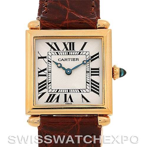 This image shows the front view of a Cartier Tank Obus Yellow Gold Silver Dial Yellow Gold Silver Dial watch, displaying its dial, Roman numerals, case, and part of the leather strap.