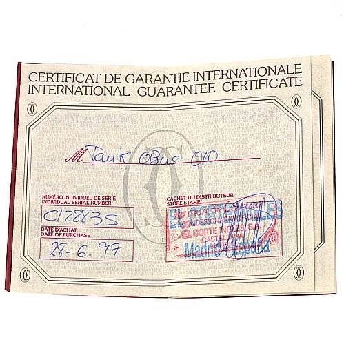 The image shows the international guarantee certificate for the Tank Obus model by Cartier, with stamps and handwritten details.