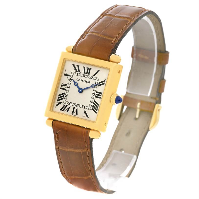 The Cartier Tank Obus W1512256 Yellow Gold Silver Dial W1512256 Yellow Gold Silver Dial watch is shown at an angled side view, displaying its gold case, Roman numeral dial, and brown leather strap.