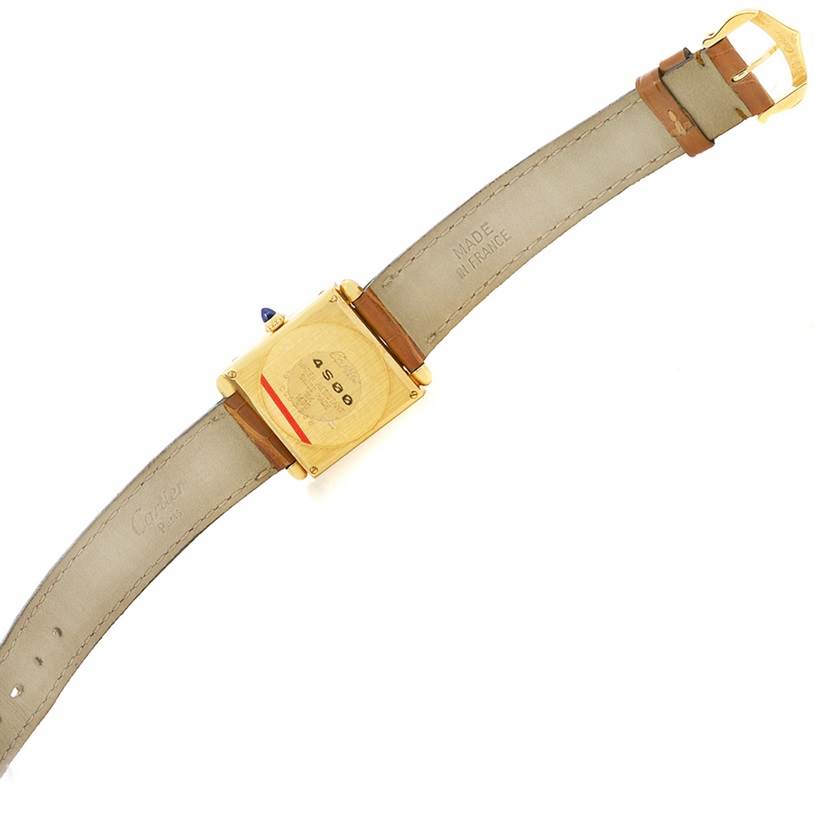 The image shows the back view of a Cartier Tank Obus W1512256 Yellow Gold Silver Dial W1512256 Yellow Gold Silver Dial watch, displaying the case back, straps, and buckle.
