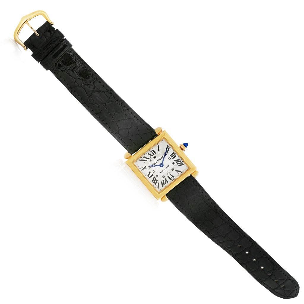 This image shows the full view of a Cartier Tank Obus W1527551 Men's Yellow Gold Silver Dial W1527551 Men's Yellow Gold Silver Dial watch, displaying the black strap and gold square case with a white dial.
