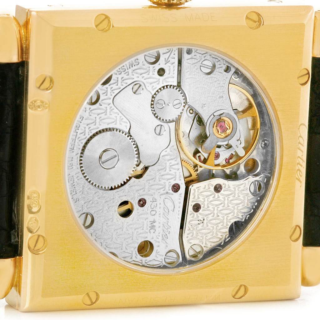 This image shows the back side of the Cartier Tank Obus W1527551 Men's Yellow Gold Silver Dial W1527551 Men's Yellow Gold Silver Dial watch, showcasing its exposed mechanical movement.