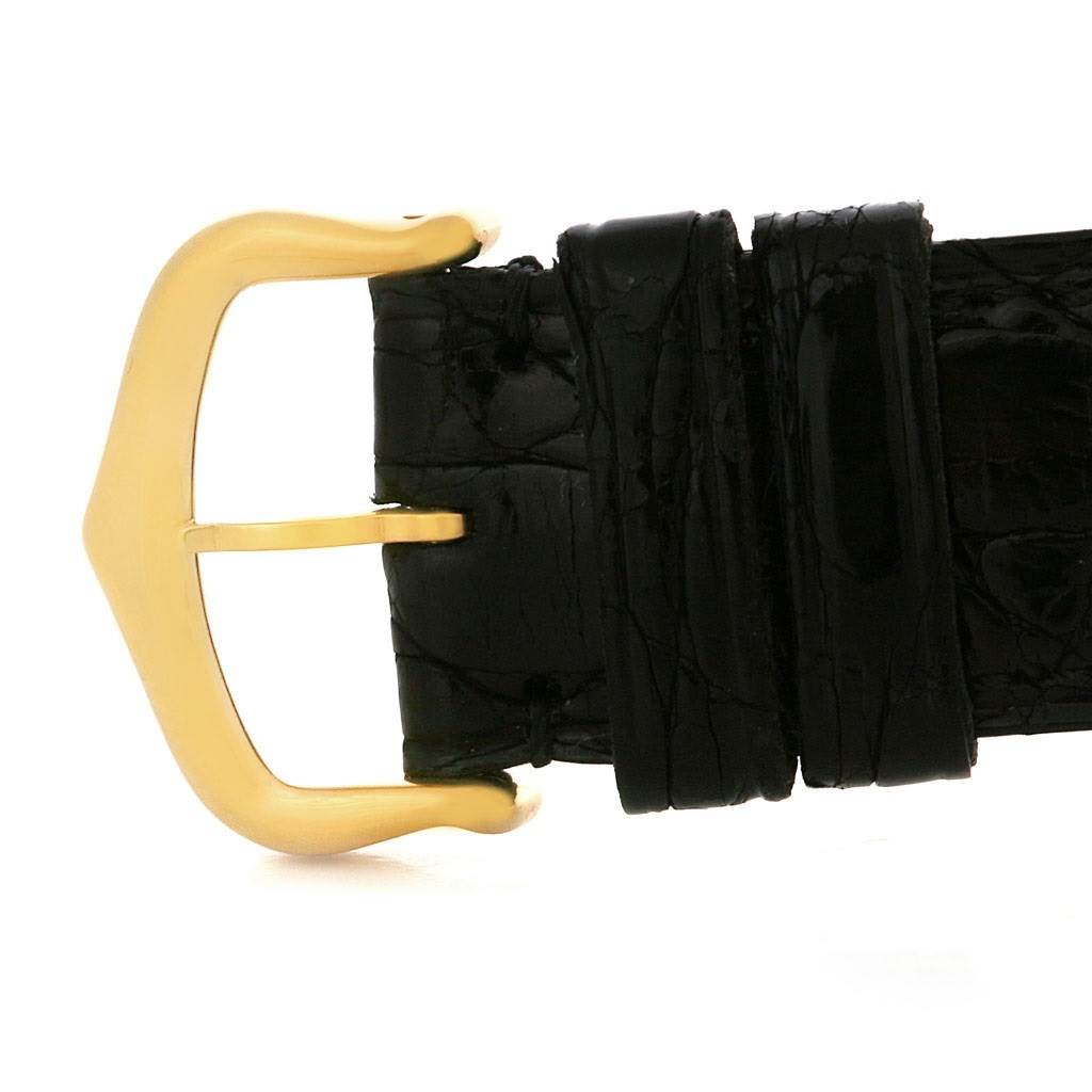 This image shows a close-up of the leather strap and gold buckle of the Cartier Tank Obus W1527551 Men's Yellow Gold Silver Dial W1527551 Men's Yellow Gold Silver Dial watch.