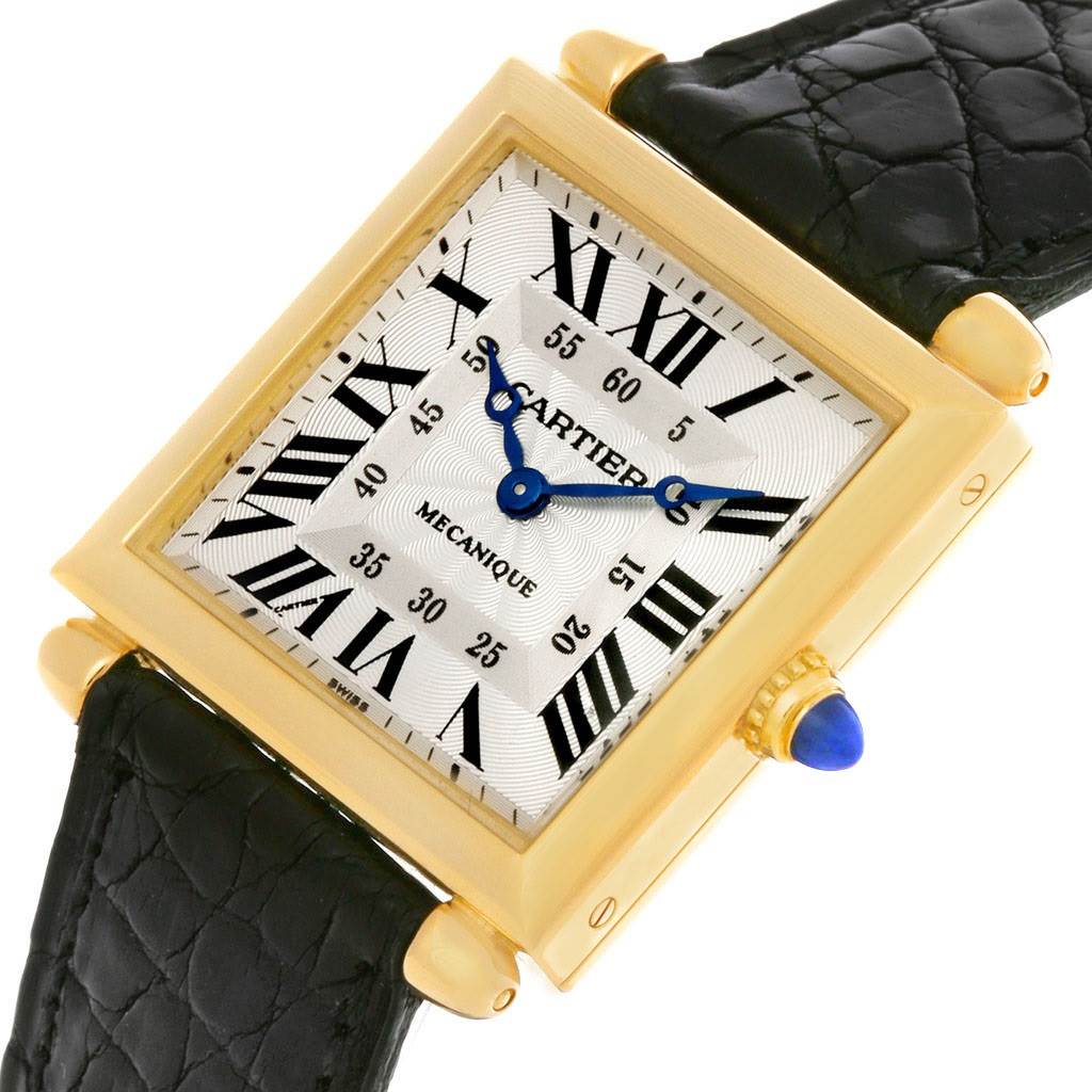 This image shows a top-view angle of the Cartier Tank Obus W1527551 Men's Yellow Gold Silver Dial W1527551 Men's Yellow Gold Silver Dial watch, highlighting its face, Roman numerals, and leather strap.