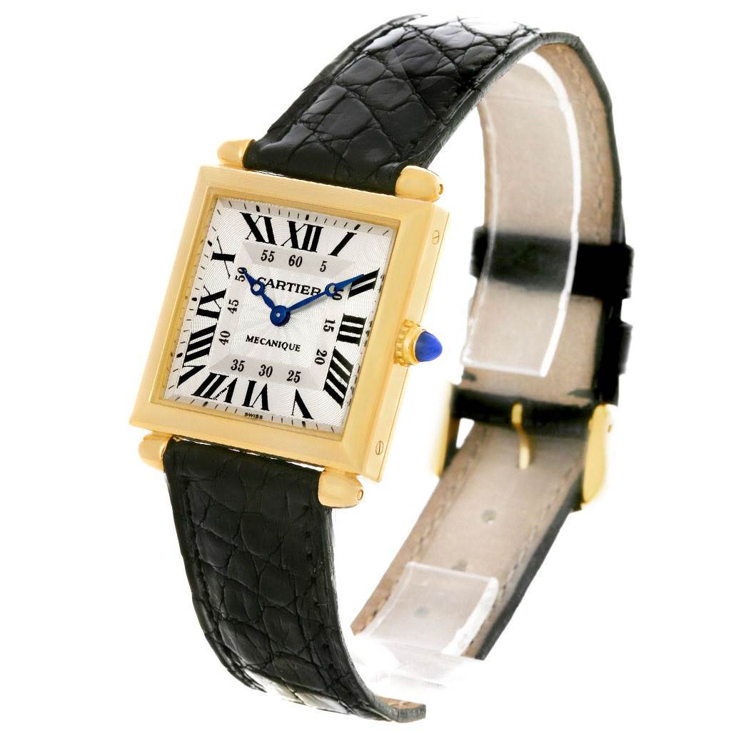 The Cartier Tank Obus W1527551 Men's Yellow Gold Silver Dial W1527551 Men's Yellow Gold Silver Dial watch is shown at a slight right angle, displaying its face, leather strap, and gold case.