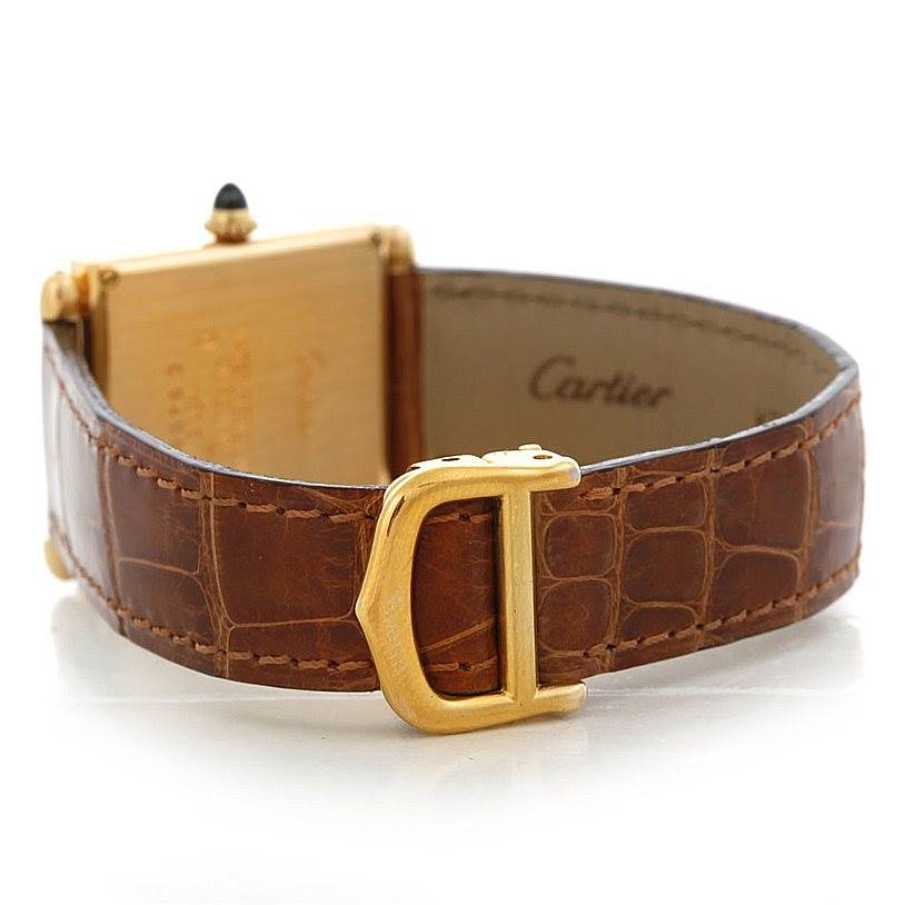 This image shows the back view of a Cartier Tank Obus Men's Yellow Gold Silver Dial Men's Yellow Gold Silver Dial watch, highlighting the leather strap and gold buckle.