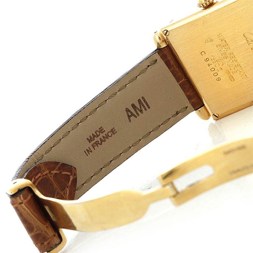 This image shows the back angle of the Cartier Tank Obus Men's Yellow Gold Silver Dial Men's Yellow Gold Silver Dial watch, including part of the strap and clasp.