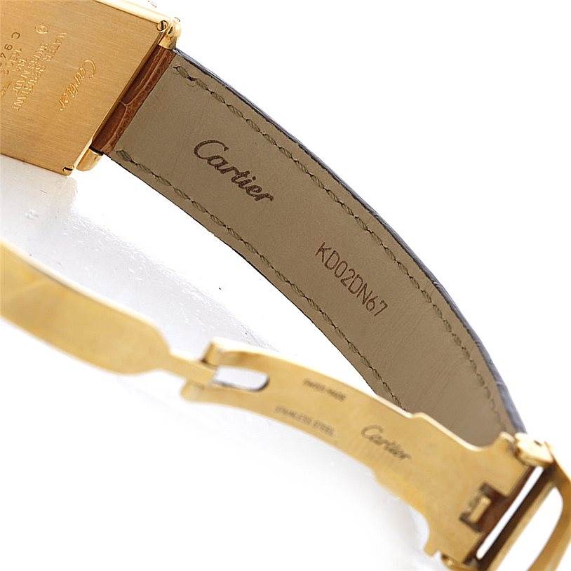 The image shows the underside of the strap and clasp of a Cartier Tank Obus Men's Yellow Gold Silver Dial Men's Yellow Gold Silver Dial watch, featuring the Cartier branding and model number.