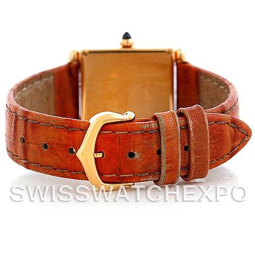 The image shows the back view of the Cartier Tank Obus Men
s Yellow Gold Silver Dial Men
s Yellow Gold Silver Dial watch highlighting its leather strap and gold buckle.