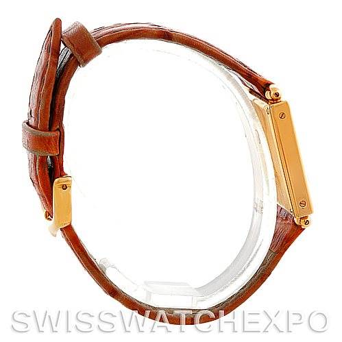 This Cartier Tank Obus Men
s Yellow Gold Silver Dial Men
s Yellow Gold Silver Dial watch is displayed in a side view, showcasing its rectangular case and leather strap.