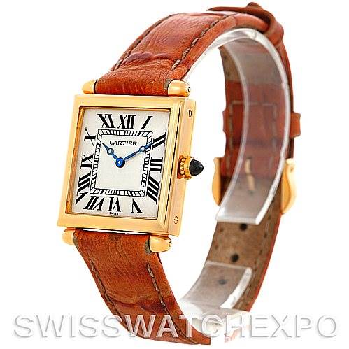 The image shows a Cartier Tank Obus Men
s Yellow Gold Silver Dial Men
s Yellow Gold Silver Dial watch angled to display the face, leather strap, and side crown.