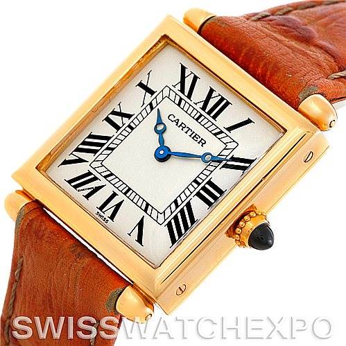 The image shows a close-up, angled view of the Cartier Tank Obus Men
s Yellow Gold Silver Dial Men
s Yellow Gold Silver Dial watch, featuring its square case, Roman numerals, blue hands, and leather strap.