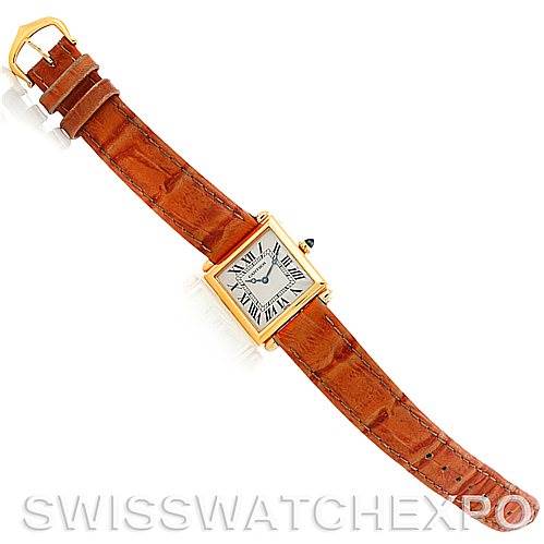 This image shows a top view of a Cartier Tank Obus Men
s Yellow Gold Silver Dial Men
s Yellow Gold Silver Dial watch, detailing its brown leather strap and gold rectangular case.