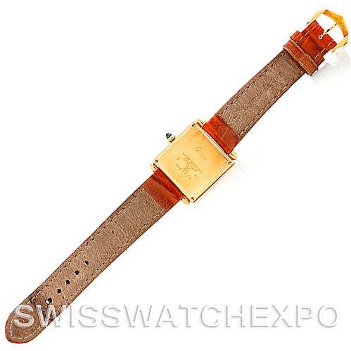 This image shows the back view of a Cartier Tank Obus Men
s Yellow Gold Silver Dial Men
s Yellow Gold Silver Dial watch with its case, leather strap, and buckle visible.