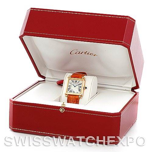 The Cartier Tank Obus Men
s Yellow Gold Silver Dial Men
s Yellow Gold Silver Dial watch is displayed at an oblique angle within its red Cartier box, showcasing the face and leather strap.