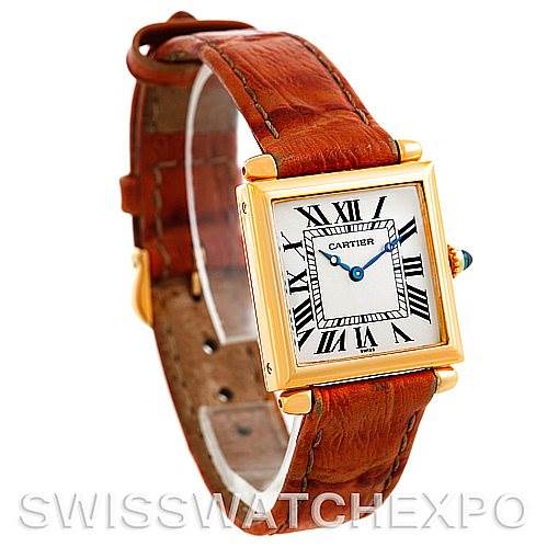 This image shows a Tank Obus watch by Cartier from a front-right angle, highlighting the dial, case, crown, and leather strap.