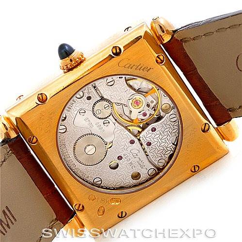 The image shows the back view of a Cartier Tank Obus W1527551 Men's Yellow Gold Silver Dial W1527551 Men's Yellow Gold Silver Dial watch, showcasing its intricate movement and internal components.