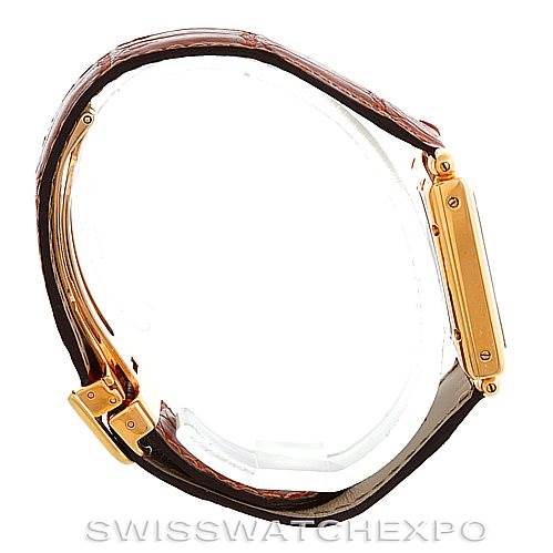 The image shows a side profile view of the Cartier Tank Obus W1527551 Men's Yellow Gold Silver Dial W1527551 Men's Yellow Gold Silver Dial watch, highlighting the brown strap, gold case, and clasp.