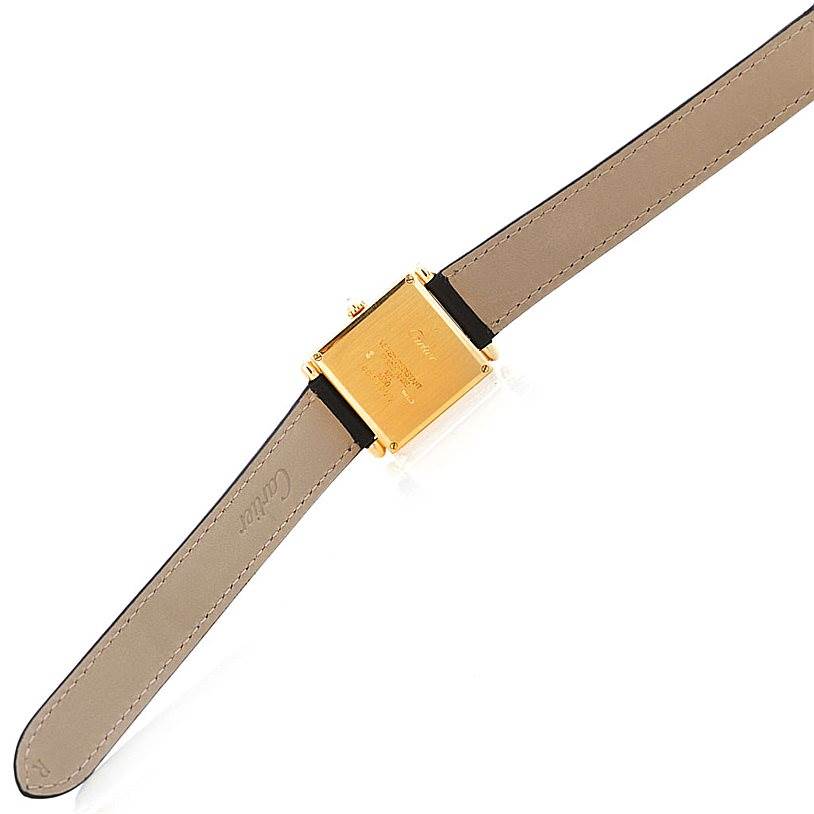 This image shows the back and strap of the Cartier Tank Obus W1512256 Men's Yellow Gold Silver Dial W1512256 Men's Yellow Gold Silver Dial watch, highlighting its gold case and brown leather band.